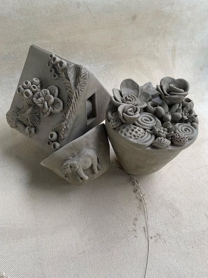 The same beautiful handbuilt sculptures, highlighting the fine details and imaginative forms that students create.