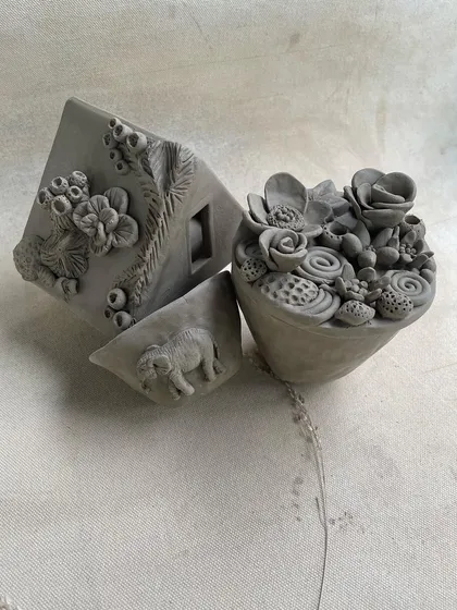 The same beautiful handbuilt sculptures, highlighting the fine details and imaginative forms that students create.