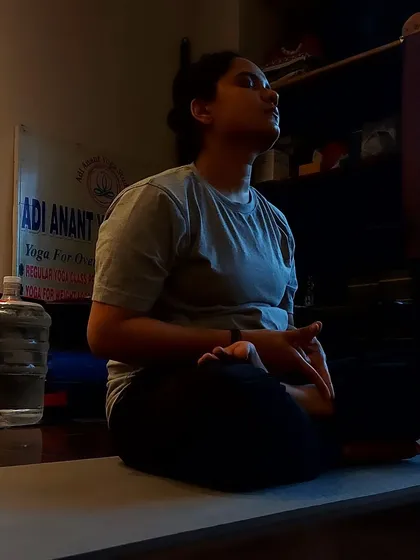 A close-up of a student in meditation, practicing Yoni Mudra to connect with their inner energy.