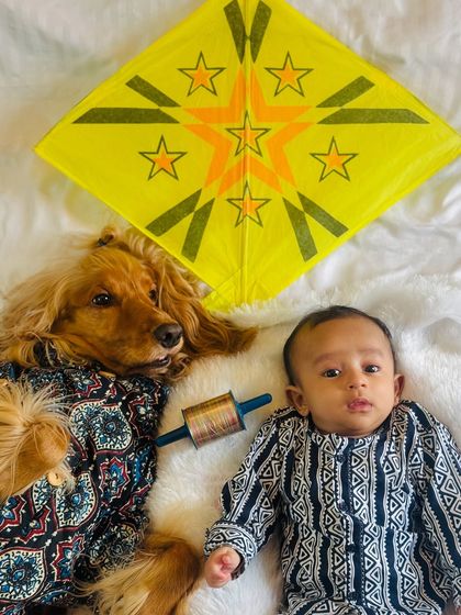 The two brothers lying side-by-side, celebrating the kite festival together.