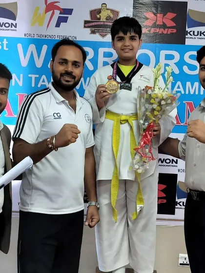 A young student on the podium at the Warriors Cup Open Taekwondo Championship. We prepare our students for success from their very first tournaments.