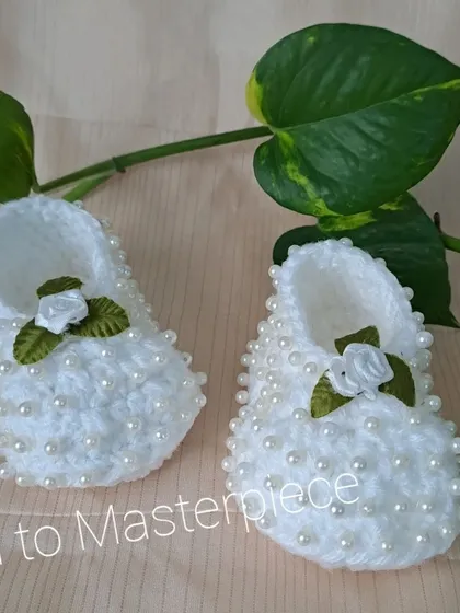 These white booties are fully embellished with pearls and feature a small white satin rose, combining two of my most popular decorative elements.