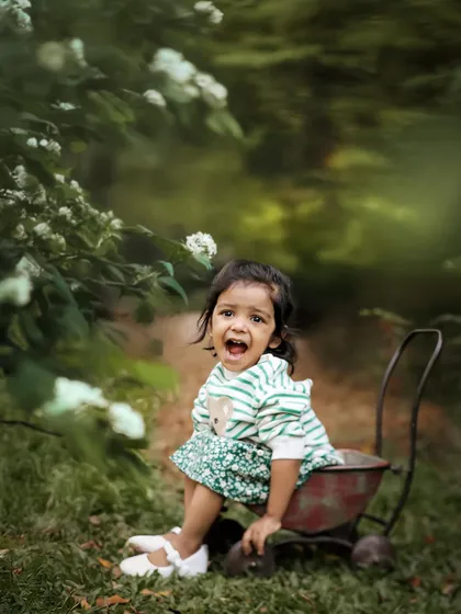 A moment of pure expression. Outdoor shoots are perfect for capturing a child's true personality. Whether it's a loud giggle or a quiet moment of thought, the natural environment helps them feel free.
