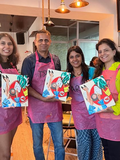 A group of four with their finished abstract paintings. It's great to see friends and colleagues bonding over art.
