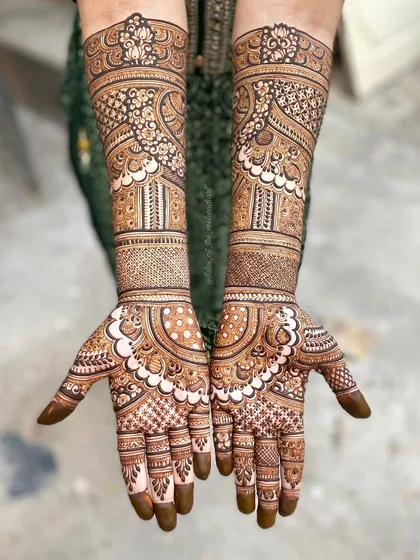 A complete view of a heavy, intricate mehendi design. The patterns are dense and detailed, perfect for a bride or for a grand celebration.