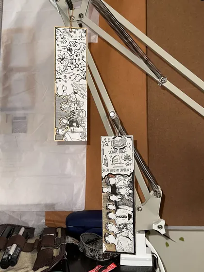 A couple of custom bookmarks hanging in my studio. I love seeing the different stories and themes come to life in these small, personal pieces.