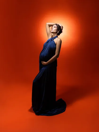 I wanted to portray the light within a mom. The orange background represents sunshine, beautifully contrasting with the deep blue dress to create a divine, glowing effect.