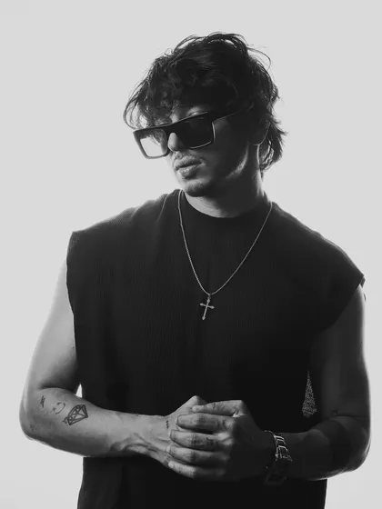 A powerful black and white shot with sunglasses. This image combines a cool, mysterious vibe with a strong, confident posture.