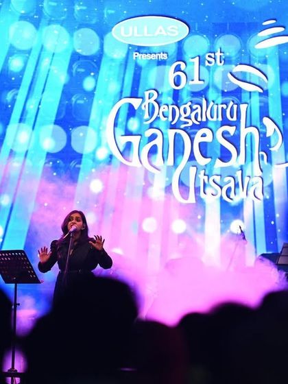 The stage at Bengaluru Ganesh Utsava, with a huge screen and dynamic lighting, creates an amazing visual spectacle. It's the perfect setting for a large-scale Carnatic fusion concert.