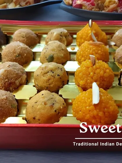 A beautiful gift box filled with our traditional Indian delights. This assortment includes Motichoor Ladoos and Besan Ladoos, showcasing the variety we offer for festive gifting.