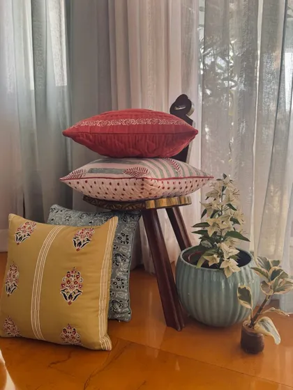 A playful stack of our block printed cushions. The mix of colors and traditional motifs showcases the versatility of this ancient craft, bringing a touch of heritage into the modern home.