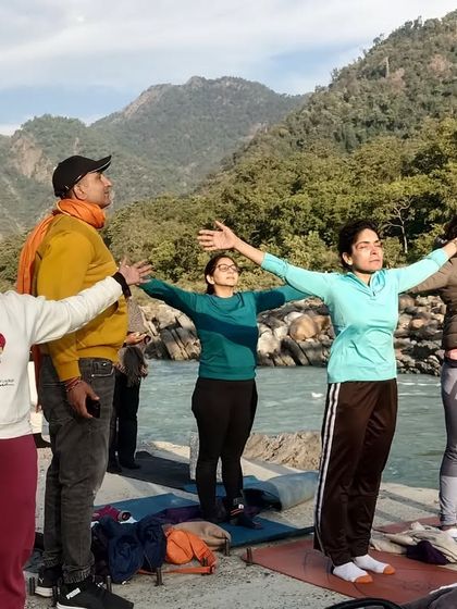 A morning yoga session by the river. We practice asanas with open arms, greeting the sun and absorbing the energy of the beautiful Rishikesh landscape.