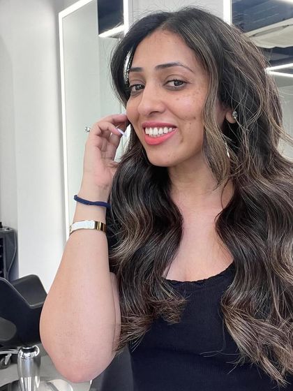 A happy client showing off her new signature balayage. The color is natural, dimensional, and perfectly suited to her.