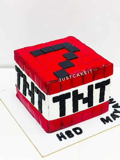 A Minecraft TNT block cake. This simple but effective design is perfect for fans of the popular game and is made with minimal fondant.