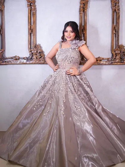 A happy, smiling portrait in the grey gown.