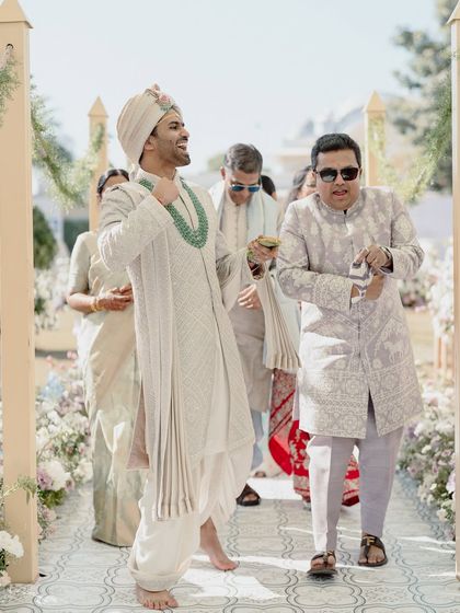 A candid shot of the groom dancing his way to the mandap, capturing the celebratory spirit of the day.