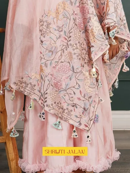 A close-up of the beautiful printed cape with tassel details. I use soft fabrics and unique prints to create these one-of-a-kind pieces.