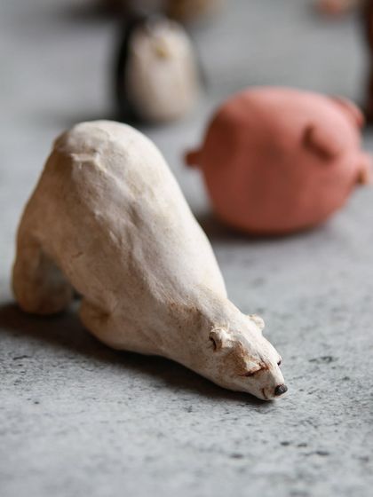 A close up of a beautifully sculpted polar bear, one of the many adorable creations from our miniature animal sculpting workshop.
