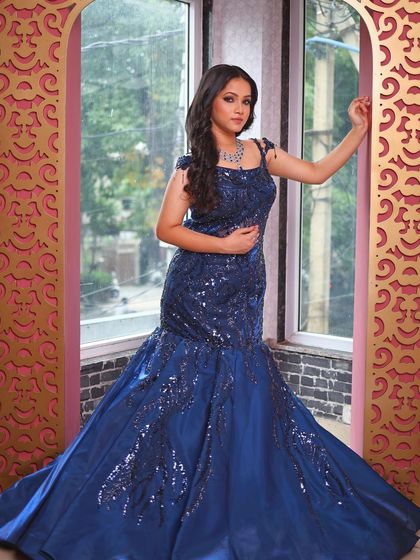 A classic portrait pose in our stunning blue fish-cut gown.