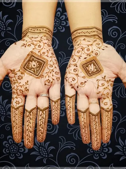 A simple yet elegant design with a central lotus motif in a diamond frame. The delicate vines on the back of the hand add a touch of grace.