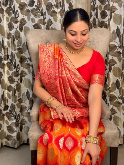 A seated portrait showcasing the grace of a traditional saree look. The makeup is kept timeless to complement the rich fabric and classic draping of the saree.