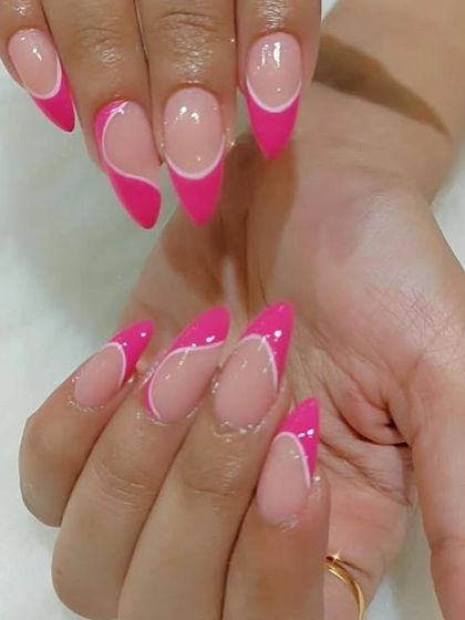 A full view of the modern pink abstract tip manicure on stiletto nails.