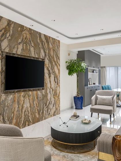 The TV unit is a statement piece in itself. We used a unique, strikingly patterned marble for the wall, adding an element of excitement and sophistication to the main living area.