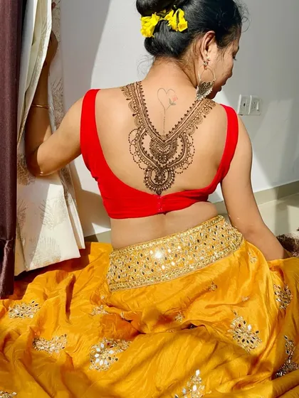 A side view of the back piece, highlighting the delicate details and the small heart tattoo it was designed around.