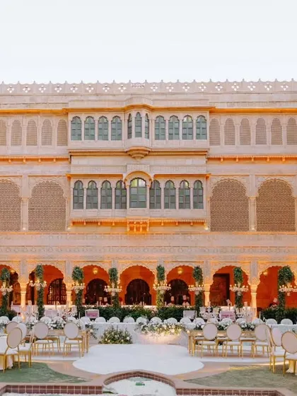 The Suryagarh courtyard transitioning from day to night, with warm lighting beginning to glow. We meticulously plan the lighting to transform the mood of the space.