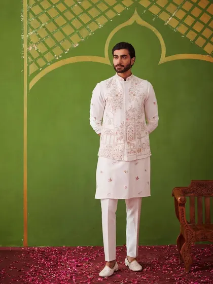 A full-length view of the white kurta set. The clean lines and the detailed waistcoat make it a timeless and versatile outfit for any festive occasion.
