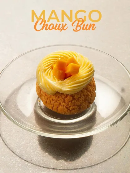 Our Mango Choux Bun, a delightful twist on the classic pastry. The light choux is filled with a luscious mango cream, offering a burst of tropical flavour.
