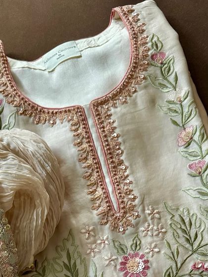 This elegant ensemble, crafted from pure silk chanderi, was part of a mother-daughter festive combo. It showcases a harmonious blend of machine and hand embroidery, perfect for creating coordinated family looks.