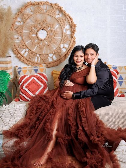 A cozy and glamorous couple's portrait in our boho setup. The rich brown gown and the warm, earthy tones of the decor create a beautiful, inviting atmosphere.