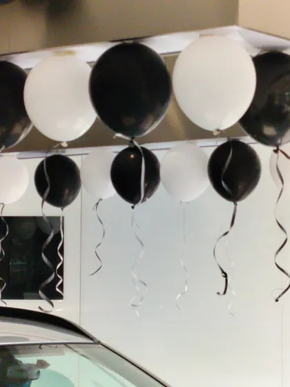 A close-up of the black and white balloon decor used at the NEXA showroom. We pay attention to details like matching ribbons and precise placement to ensure a polished and professional look for our corporate clients.