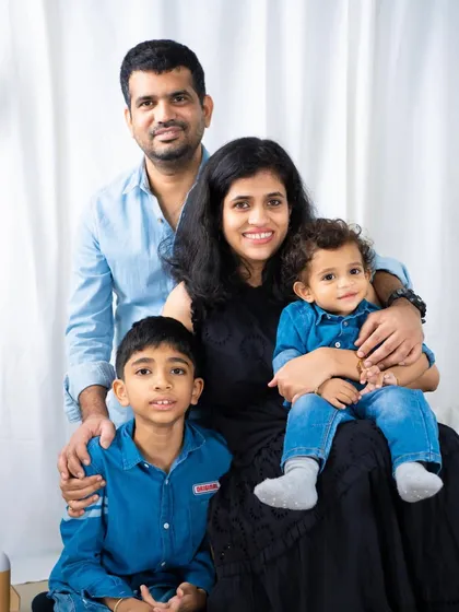 A classic family portrait with everyone dressed in coordinating denim blue. This timeless look is perfect for a family photo you'll display for years.