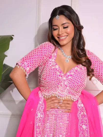 A happy, candid moment in our bright pink lehenga. We love providing outfits that make our clients feel joyful and confident.
