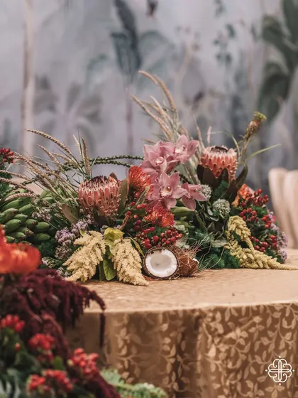 A close-up of a tablescape from the 'Orchard of Life' event, featuring coconuts and other tropical elements.