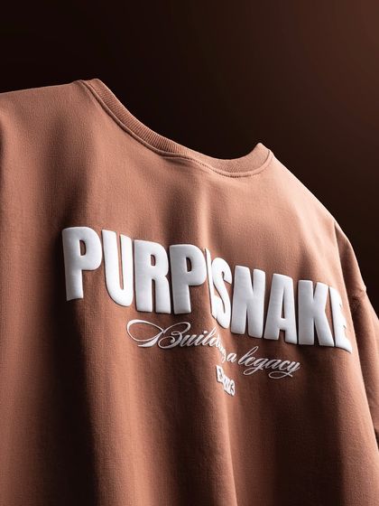 Another angle of the brown t-shirt, shot to emphasize the three-dimensional quality of the white printed text.