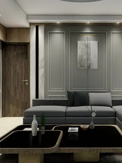This design demonstrates a perfect fusion of classical and modern interior styles. The wall is treated with traditional panel mouldings but finished in a contemporary grey, while the sleek, low-profile sectional sofa maintains a modern sensibility.