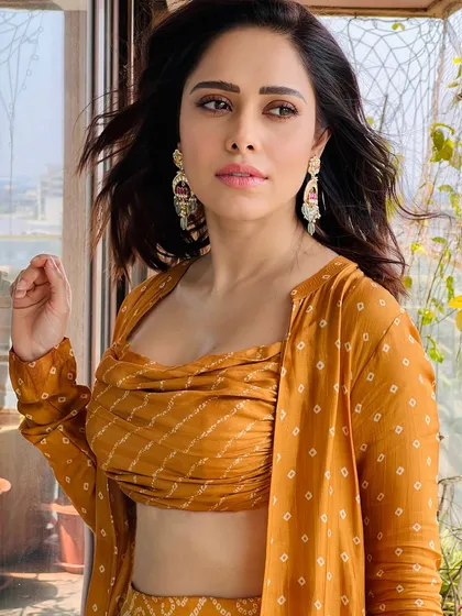 A vibrant bandhani print co-ord set for Nushrratt Bharuccha. This look, featuring a draped top and matching pants with a jacket, is perfect for a festive brunch or a casual wedding event.