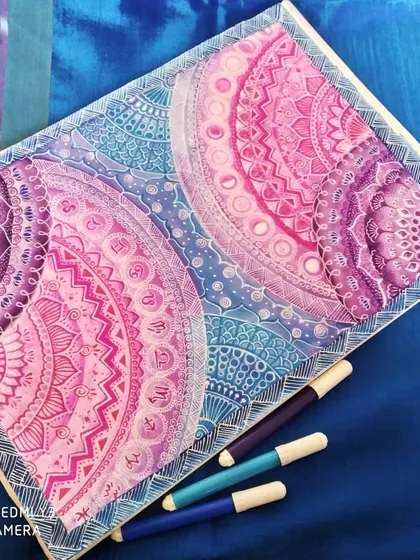 Inspired by the cosmos, this large mandala painting blends vibrant pinks, purples, and blues to create a galaxy effect. The detailed patterns and symmetrical design are intended to draw you in, making it a perfect statement piece for any wall.