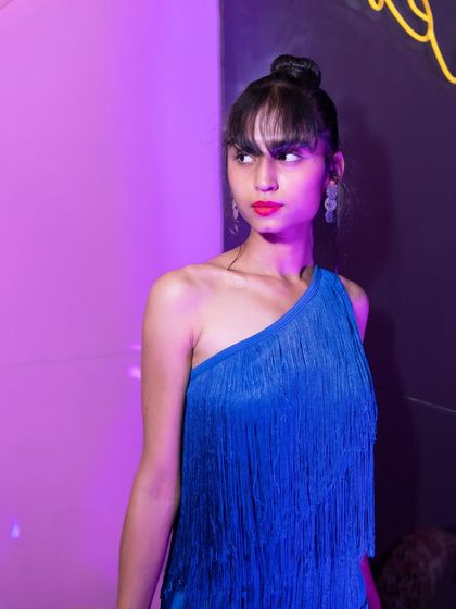 A guest in a stunning blue fringe dress, adding to the glamour of the night.