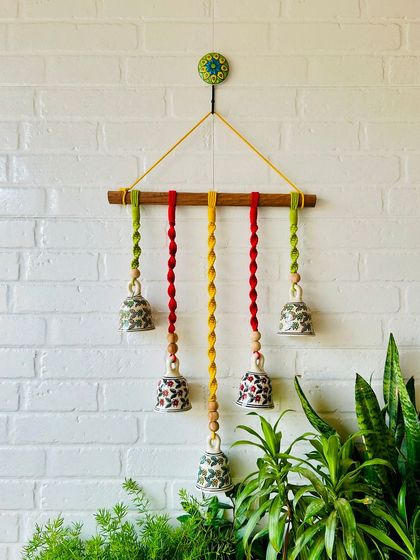 Welcoming 'Mac & Chime' to our collection. This wall hanging features intricately knotted colored cotton cords and hand-painted ceramic bells, adding a delicate touch of sound and elegance to any space.