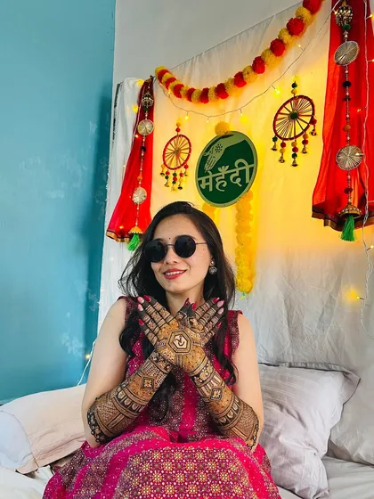 Another shot of the happy bride with her sunglasses, looking cool and confident. Her mehendi is a stunning accessory to her bridal look.