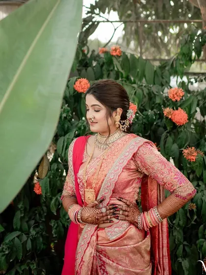 An artistic shot of the bride in a beautiful outdoor setting. The makeup is flawless and photogenic, looking stunning in natural light.