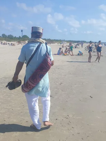 Walking on a beach in Europe, with my yoga mat. The path of a yogi is to find stillness and practice wherever you are, be it a mountain top or a sandy shore.