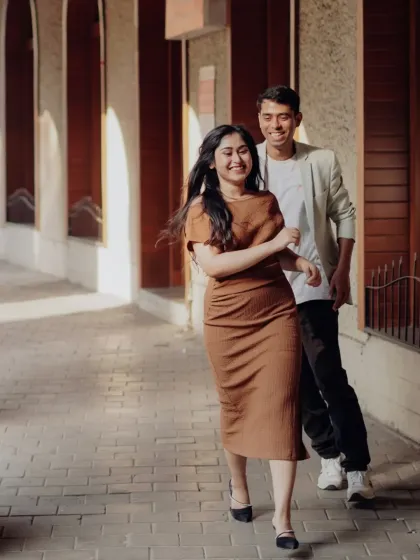 A playful chase through a sunlit city corridor. We encourage laughter and movement to capture your genuine connection and energy as a couple.