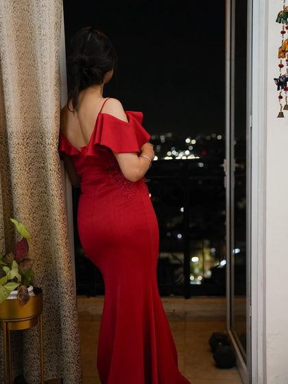 A full-length shot of the red gown against the city lights, perfect for a dramatic and elegant look.