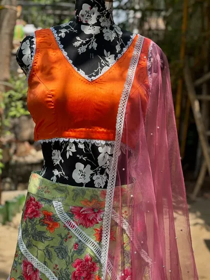 A close-up of the blouse and dupatta. The delicate lace border on the blouse is a sweet detail.