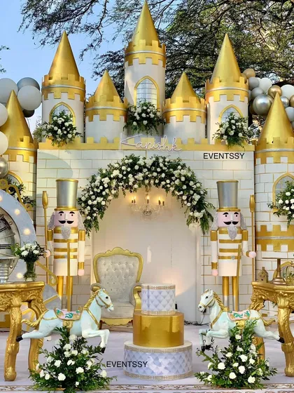 A grand and opulent royal prince celebration, featuring a full castle facade, life-sized nutcracker figures, and carousel horses.